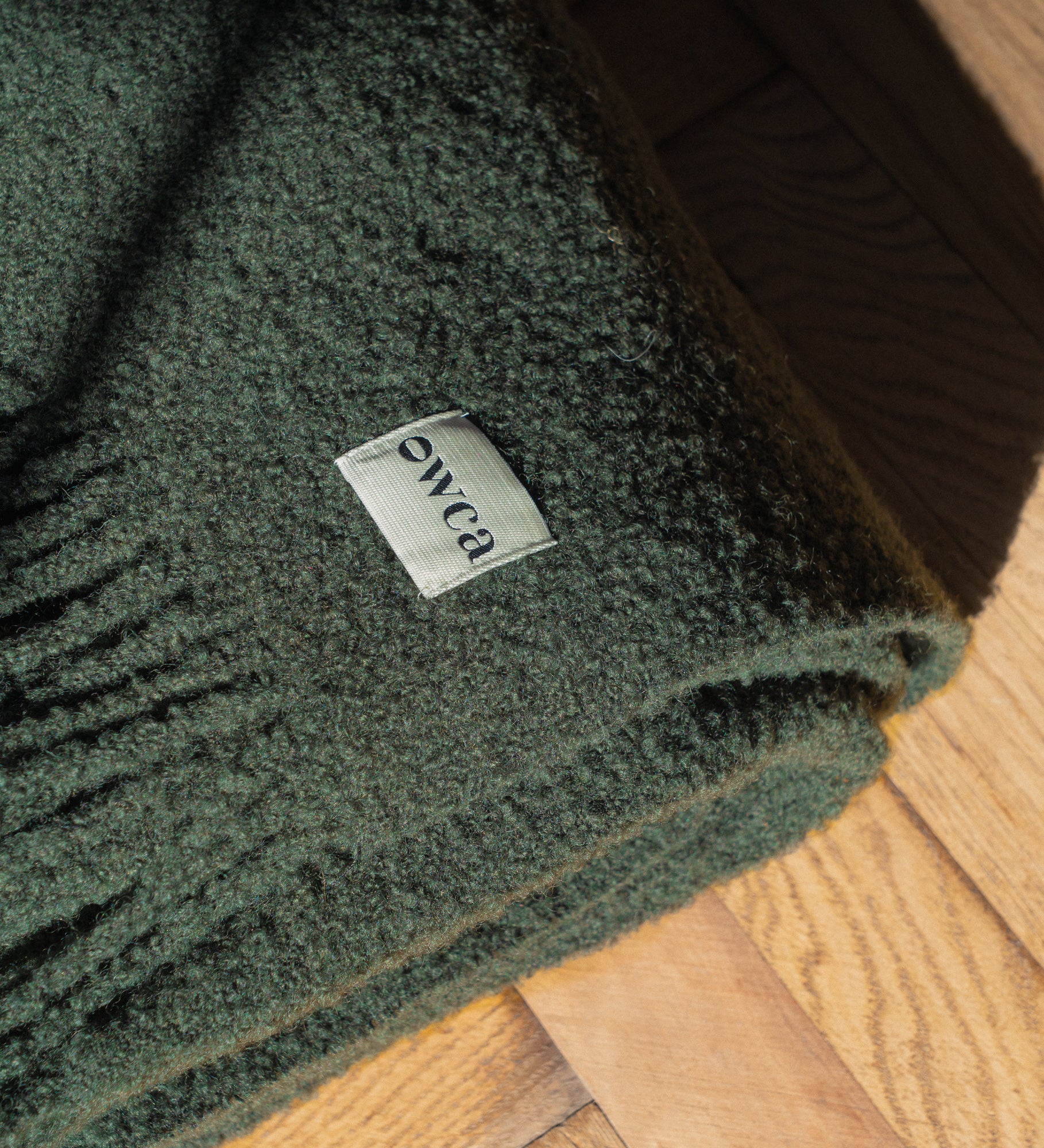 HELIOS Merino boucle blanket with fringe - sosnowy